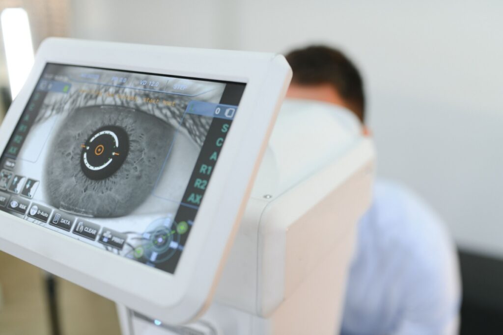 Digital eye imaging monitor displaying a detailed scan of a patient's eye during an exam.